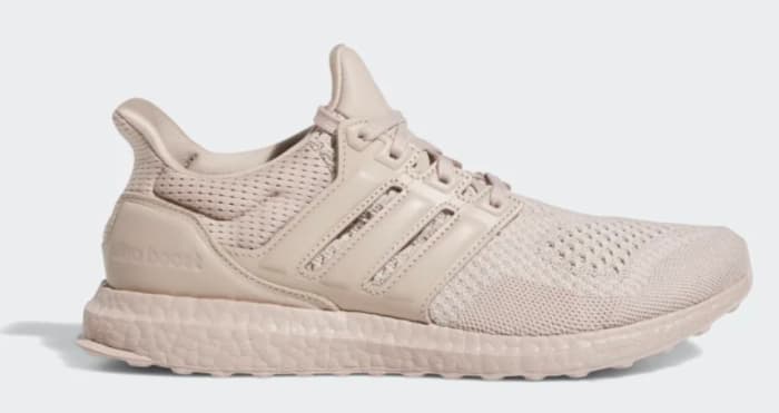 Side view of a tan adidas shoe.